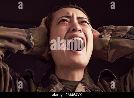 PTSD, crying and trauma with a woman soldier shouting or screaming in studio on a dark background. Scream, grief and tears with a young army female Stock Photo