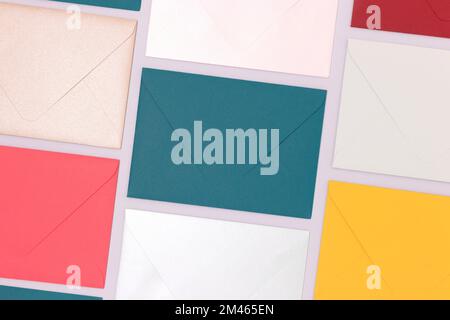 Multicolored envelopes neatly laid out on a blue background. Creative business concept. Stock Photo