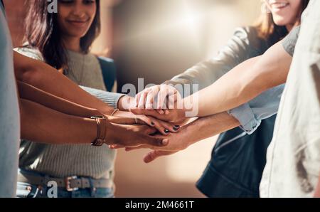 Diversity, hands together and team support for student collaboration, education motivation and team building project success. Interracial group of Stock Photo