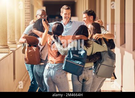 University, students and diversity friends hug at campus in support, motivation and happiness together in education, studying and learning. Happy Stock Photo