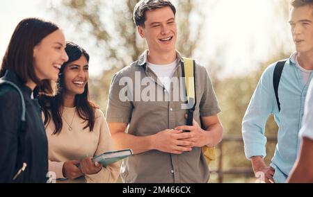 Group of friends, students and conversation outdoor, relax and happy together. Young people, standing in circle and talking on campus, bonding and Stock Photo