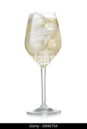 LONDON, UK - AUGUST 25, 2022: Somersby pear cider with ice cubes in original cocktail glass with logo on whit. Stock Photo