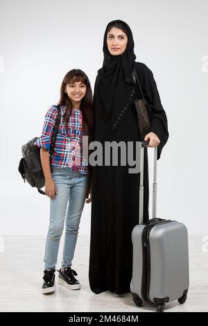 Arab mother and her daughter travelling. Stock Photo