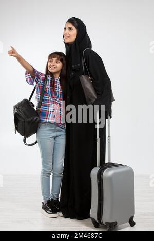 Arab mother and her daughter travelling. Stock Photo