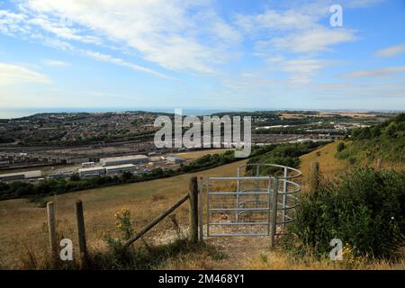 Footpath gate and view across Folkestone and across the Eurotunnel site from Crete Road West, Hawkinge, Folkestone, Kent, England, United Kingdom Stock Photo