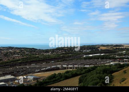 View across Folkestone and across the Eurotunnel site from Crete Road West, Hawkinge, Folkestone, Kent, England, United Kingdom Stock Photo