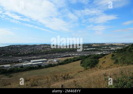 View across Folkestone and across the Eurotunnel site from Crete Road West, Hawkinge, Folkestone, Kent, England, United Kingdom Stock Photo