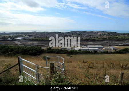 Footpath gate and view across Folkestone and across the Eurotunnel site from Crete Road West, Hawkinge, Folkestone, Kent, England, United Kingdom Stock Photo