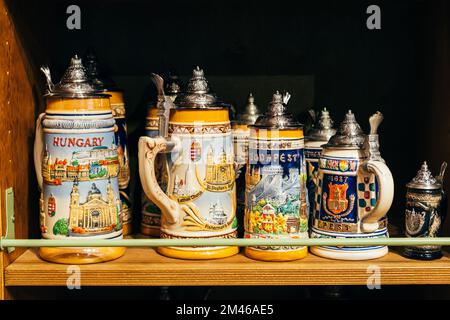 Hungary, Budapest, 17 june 2022. Hungary old souvenir mugs with metalic cover an magyar drawings on them in sunlight. Stock Photo