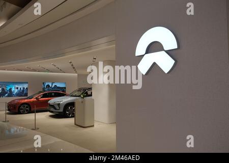 Shanghai,China-Dec.18th 2022: Nio Inc. brand logo and electric car in store. Chinese EV company Stock Photo