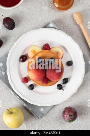 Plate with funny children's breakfast in shape of fish on beige ...