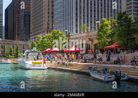 People walking along The Cove, a part of the Riverwalk public space on the Chicago River. Stock Photo