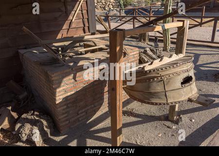 View of a typical traditional blacksmith's shop, a site for forging medieval iron, with a typical furnace and an ancient bellows blower... Stock Photo