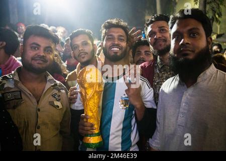 Dhaka, Bangladesh. 19th Dec, 2022. Fans pose with a replica World Cup trophy (Photo by Rizwan Hasan/Pacific Press) Credit: Pacific Press Media Production Corp./Alamy Live News Stock Photo