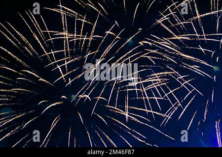 Bright light flash of fireworks, against the background of the night sky. Stock Photo