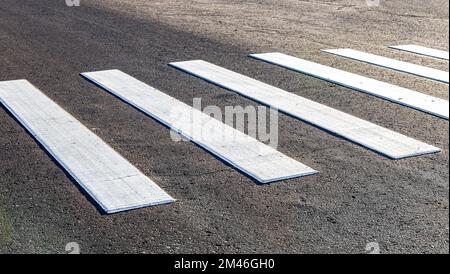 Pedestrian crossing with white stripes on the asphalt. Crosswalk on the road. Transportation background texture Stock Photo