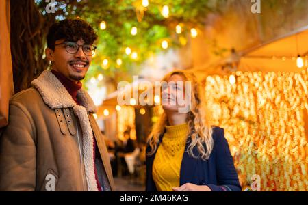 selective focus on arab young man smiling While talking with his girlfriend Stock Photo