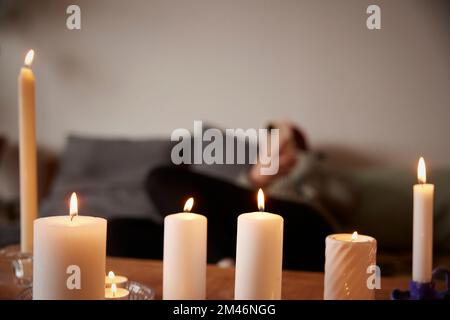 Various lit candles at home Stock Photo