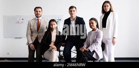 . Happy young multiethnic corporate staff, bank workers photo shoot, HR agency recruitments. Stock Photo