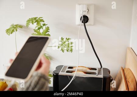 Toaster plugged into an outlet Stock Photo