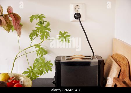 Toaster plugged into an outlet Stock Photo