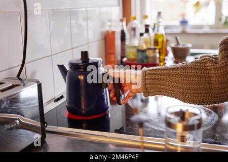 Woman preparing coffee in kitchen Stock Photo