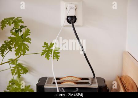 Toaster plugged into an outlet Stock Photo