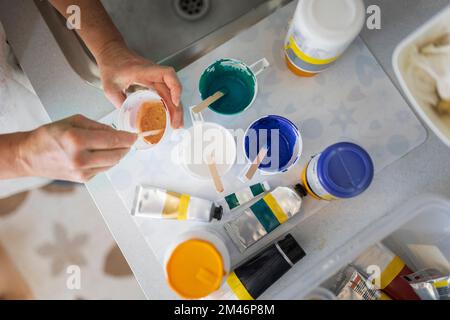 Artist mixing paints, close-up Stock Photo