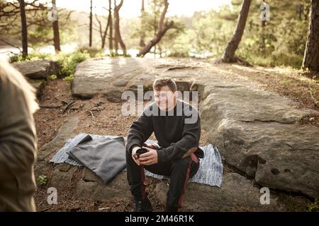 Smiling man drinking coffee outdoors Stock Photo
