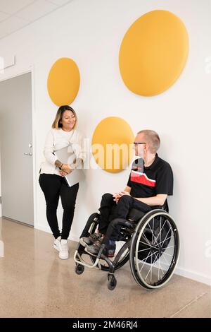 Students talking in corridor Stock Photo