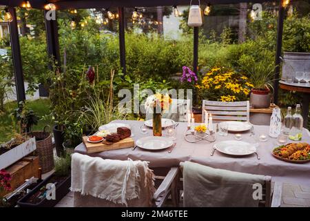 Table set in greenhouse Stock Photo