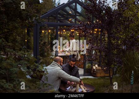 Friends talking in garden Stock Photo