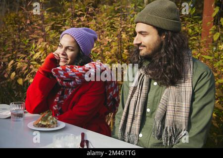 Man and woman relaxing at table Stock Photo