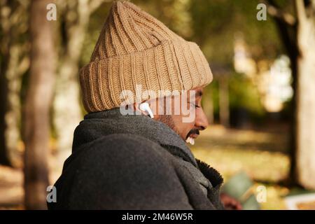 Smiling man sitting on bench Stock Photo