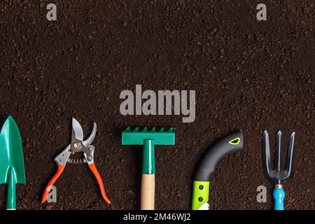 Garden tools for working on the ground. Shovel pruner rake hacksaw fork Stock Photo