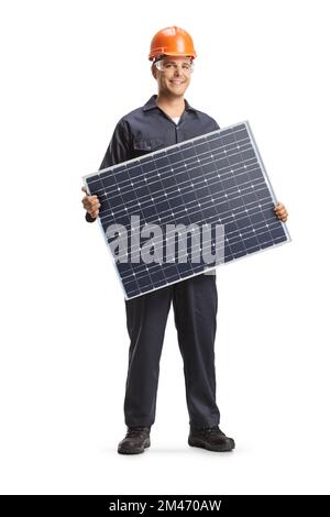 Worker in a uniform holding a solar panel isolated on white background Stock Photo