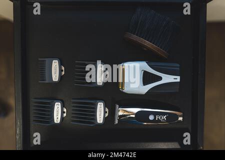 12.02.2022 Warsaw, Poland. Professional barber and hairstyling shaving kit on a shelf. High angle shot. Indoor view. High quality photo Stock Photo