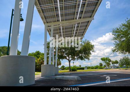 Solar panels installed over parking lot canopy shade for parked cars for effective generation of clean energy Stock Photo