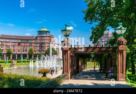 Great view of the water fountain behind the Water Tower (Wasserturm) in the square Friedrichsplatz in Mannheim, Germany; and on the right, the pergola... Stock Photo