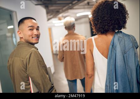 Cheerful company employee posing for the camera in the hallway Stock Photo