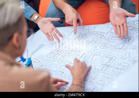 Group of draftspeople working on a drawing Stock Photo