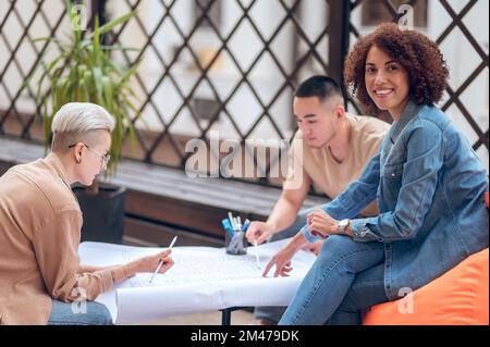 Multinational architectural team working on a site development plan Stock Photo