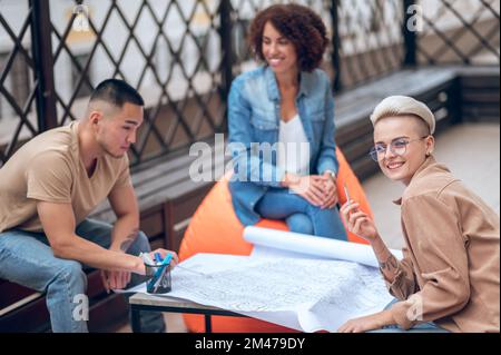 Architectural team working on a building plan on the veranda Stock Photo