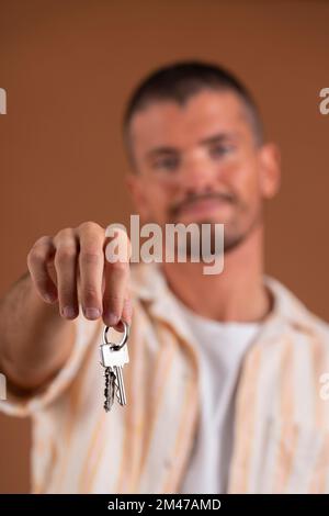Close-up of a man's hand handing over a set of keys Stock Photo
