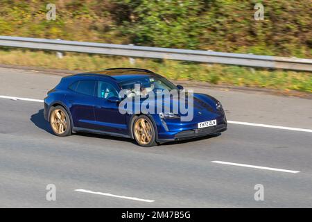 2022 Blue PORSCHE TAYCAN 4 CROSS TURISMO 4S Electricity 1 speed automatic, 93.4kWh Performance Battery Plus with gold alloy wheels; travelling on the M6 motorway UK Stock Photo