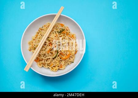 Fresh tasty noodles with vegetables in white bowl Stock Photo