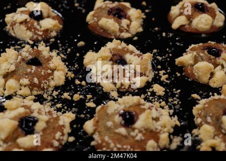 chocolate stuffed baked muffins or cupcakes in a bakery sheet Stock Photo