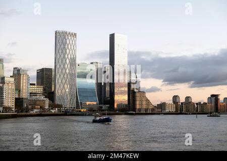 View of riverside corporate buildings at Canary Wharf buildings on Isle of Dogs from River Thames at dusk Isle of Dogs London UK 2022  KATHY DEWITT Stock Photo