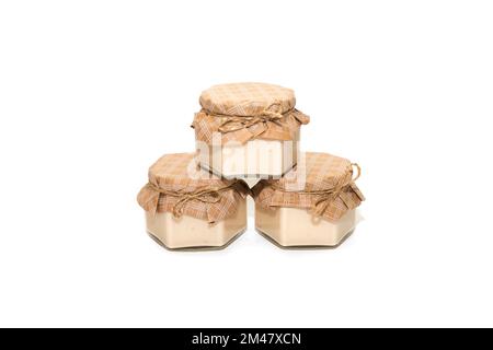Three glass jars with jam on a white background. Stock Photo