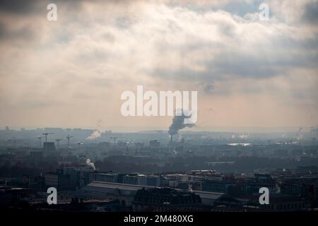 Urban smog, atmosphere polluted by smoke rising from the chimneys in the city of Lyon during winter with cloudy skies, France Stock Photo